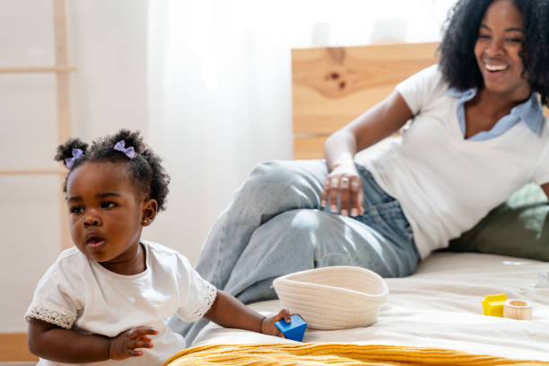 istock Toddler's playtime with mother on bed 2149213680