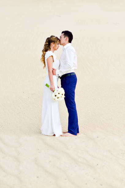 istock Beautiful newlyweds among the sand dunes 2149214221