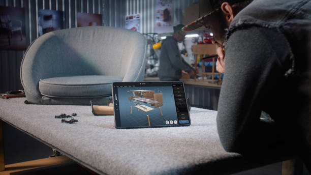 istock Designer creates 3D model of wooden bedside table using digital tablet and stylus 2149215213