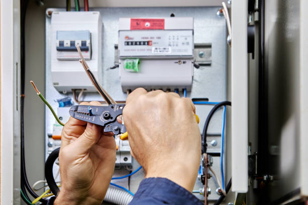 istock Connecting four-core, three-phase power cable to power supply in an outdoor electrical box, stripping ends of wires of insulation. 2149216279