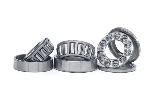 Single row tapered roller bearings and thrust ball bearings isolated on white background