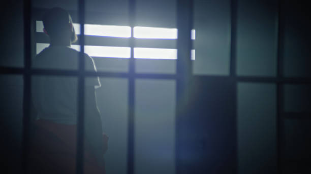 istock Male prisoner standing in prison cell 2149217816