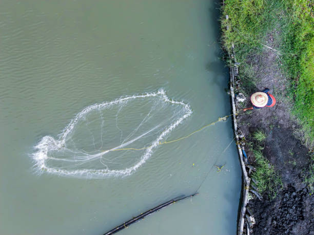 Fisherman is holding fishing net on My Khe beach.Da Nang - Vietnam.