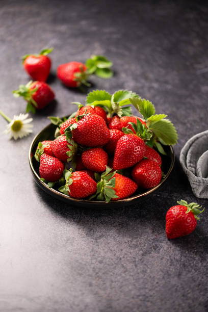istock Red ripe strawberries berries. Dark background 2149218636