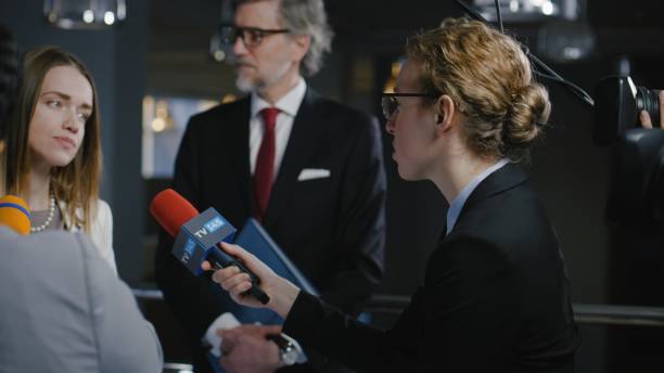 istock Female journalist interviews politician at press conference 2149219014
