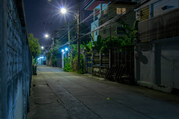 istock narrow street at night with lampposts 2149219779