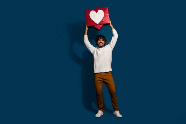 istock Full length photo of cheerful excited guy dressed white pullover rising feedback blogging like empty space isolated dark blue color background 2149220490