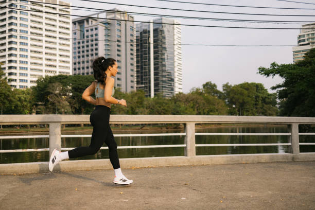 istock Thai sportswoman running during sports training on a bridge. 2149221220