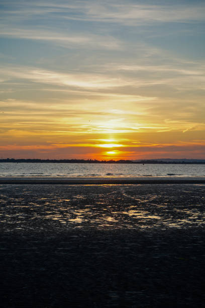 Sun set over a sandy beach and ocean in England