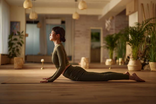 istock Relaxed Japanese woman in cobra pose at Yoga studio. 2149223253