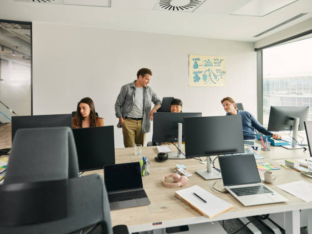 istock Team of happy web designers working on desktop PC in the office. 2149223696