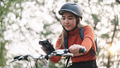 Woman using smartphone while travel by bike.