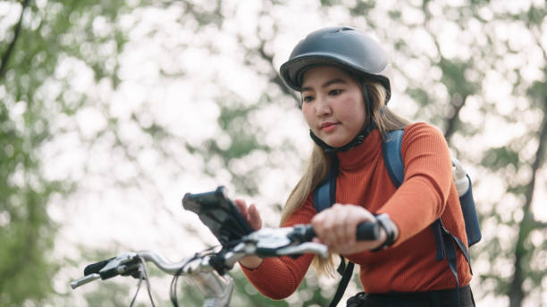 istock Woman using smartphone while travel by bike. 2149224221