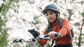 Woman using smartphone while travel by bike.