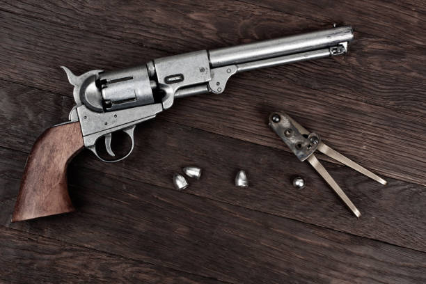 istock Old West Revolver with bullet mold and bullets. 2149224230