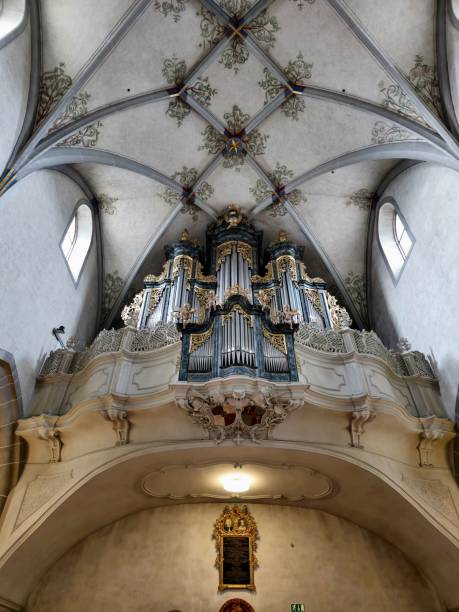 The richly decorated Gothic “Doorway of Kings” is the entrance to one of the most significant late-Gothic church buildings in Switzerland (built in 1478), with its plain elegant interior. The baroque Bossard organ and the original choir stalls are particularly worth seeing. The image shows the main nave ceiling with the beautiful pipe organ.