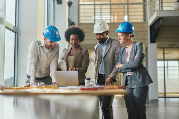 istock Team of architects working on laptop at construction site. 2149225044