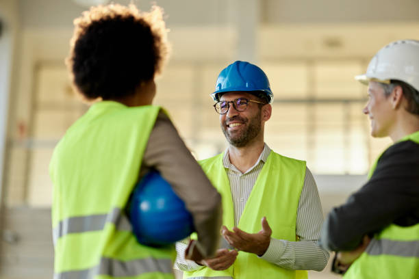 istock Team of happy civil engineers talking at construction site. 2149225133