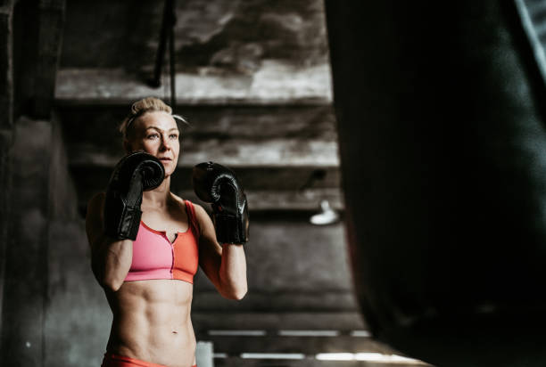 istock Woman boxing training with a punching bag 2149225486
