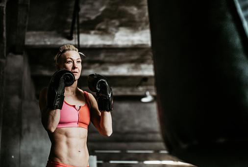 Woman boxing training with a punching bag