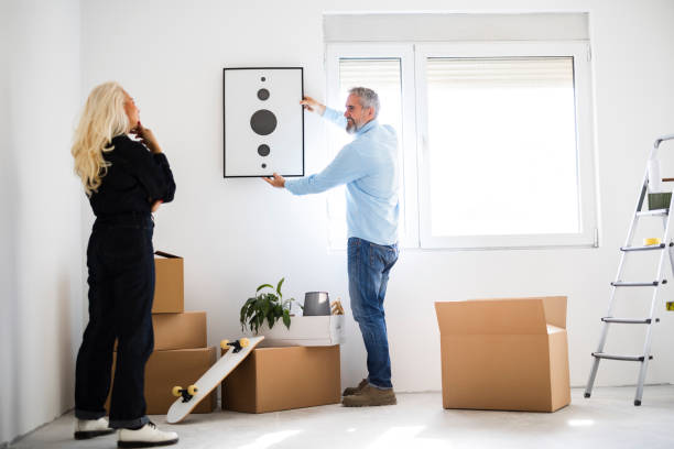 istock Couple Hanging Poster On Wall At Home 2149227213