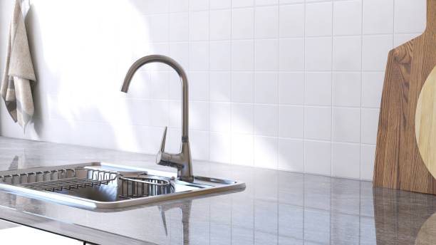 istock Gray marble kitchen table counter countertop, modern stainless sink in sunlight on square white tile wall 2149227583