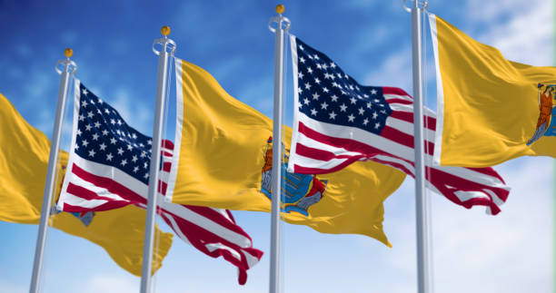 istock New Jersey state flags waving with the american flag on a clear day 2149230031