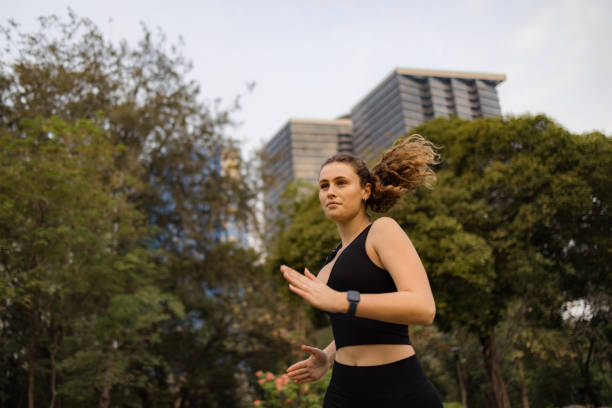 istock Young female athlete running during springtime in the park. 2149230089