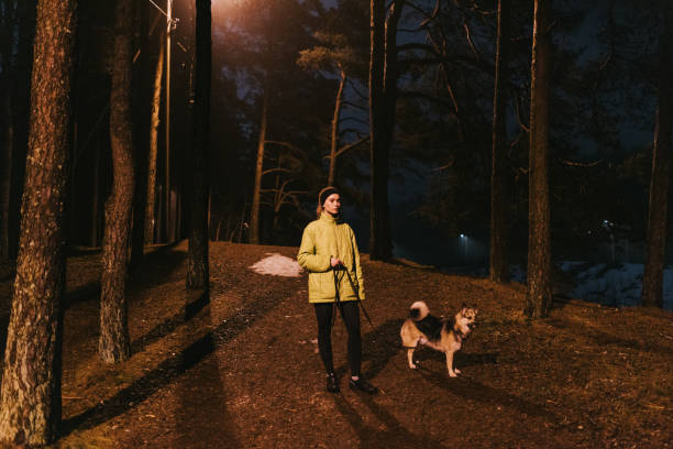 istock Young woman enjoying her evening run with her dog 2149230427