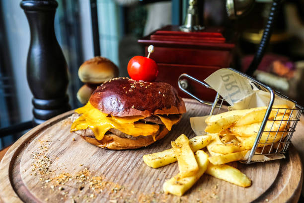 Delicious Cheeseburger and Fries on Wooden Tray
