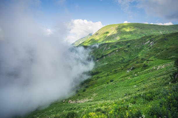Majestic clouds covering valley in the mountains