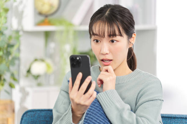 istock Surprised woman looking at smartphone 2149233330