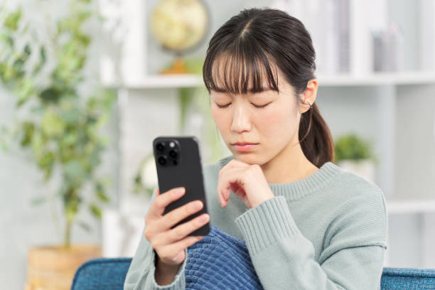 istock Sad woman looking at smartphone 2149233335