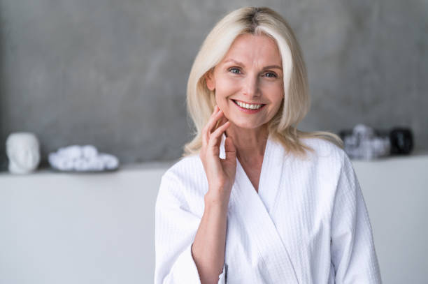 istock Woman in bathrobe, looking at camera with nice calm smile 2149233487