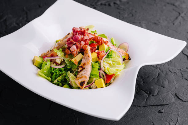 istock Fresh chicken and bacon salad on modern plate 2149234769