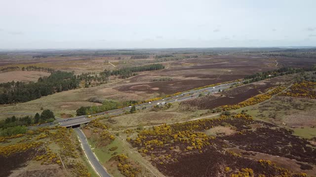 Highway in the countryside newforest uk, motorway moving cars aerial shot cinematic