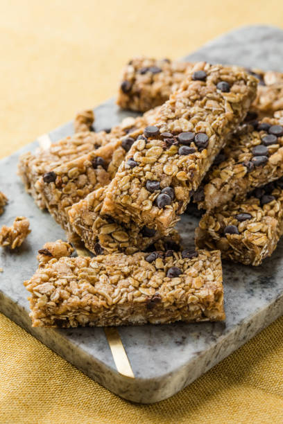 istock Various granola bars on table background. Cereal granola bars. Superfood breakfast bars with oats, nuts and berries, close up. 2149238458