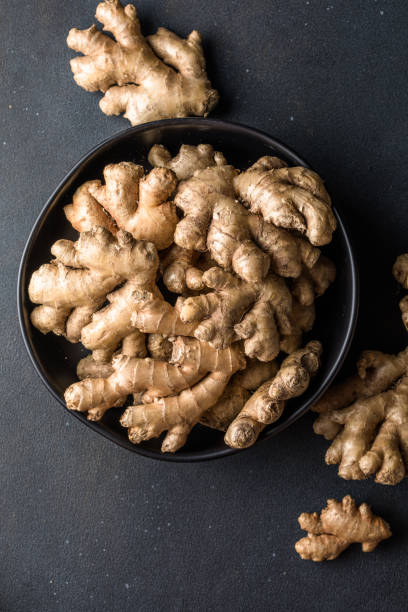 istock Ginger roots from the garden in plate on black surface 2149238791
