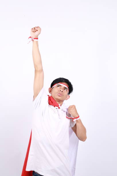 istock Asian men standing to celebrate Indonesia's independence with a flying pose 2149238814
