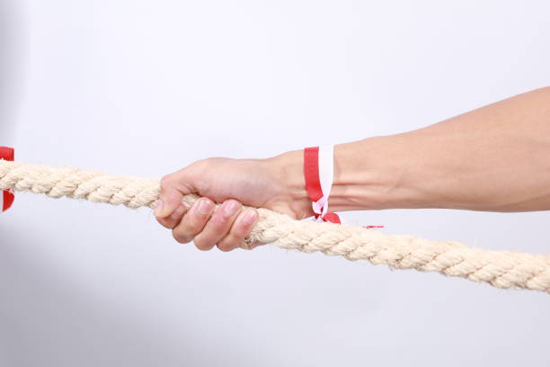 istock close up photo of Asian men celebrating independence pulling a rope 2149238895