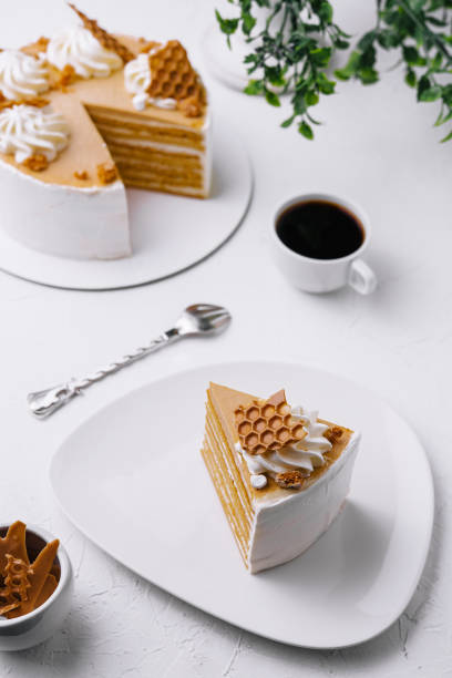 Honey layer cake with coffee on white table
