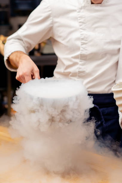 istock close-up of a chef in a white uniform in the kitchen preparing liquid nitrogen that spreads over the table 2149239750