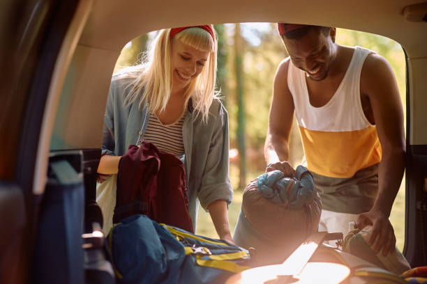 istock Young happy couple packing luggage in their camping van. 2149239896