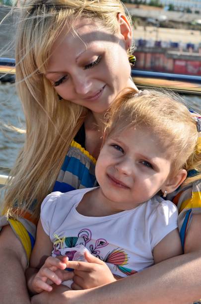 A young family with children rides on a ship on the Dnieper River in the city of Dnepropetrovsk.