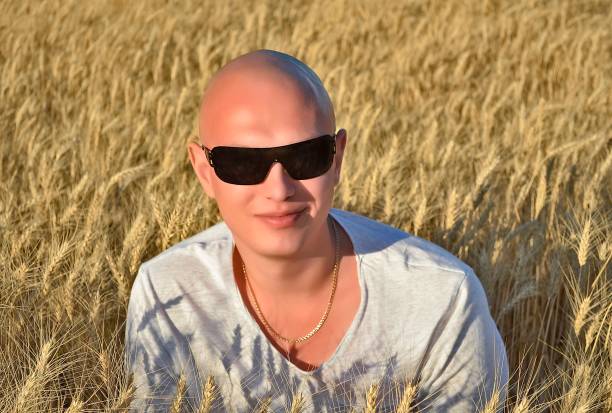 Photo session of a beautiful young woman and man in a wheat field.