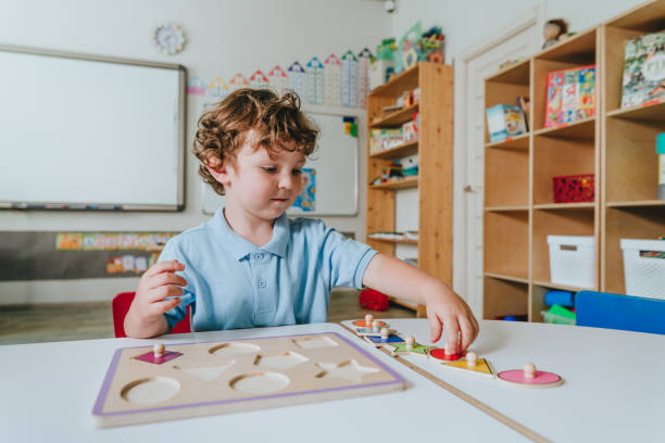 istock Boy playing with educational wooden toys in a kindergarten 2149241341