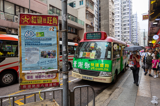 Hong Kong - January 25 2018: Aerial view of a minibus driving in the crowded streets of Mong Kok in Kowloon, Hong Kong.