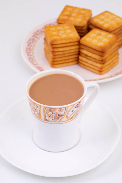 Indian Masala Chai or Morning Tea Served With Toast Isolated on White Background