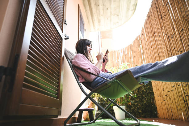 istock Young woman relaxing on terrace in a sunny day. 2149242190