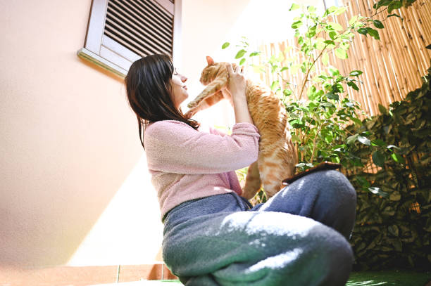 istock Woman embracing ginger cat. 2149242209